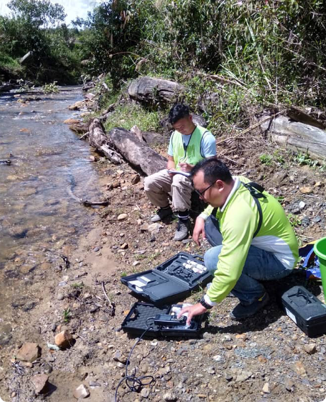 Taking water sampling for river water quality monitoring